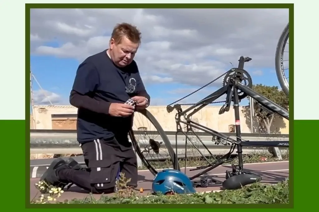 Graham Caldow repairing a puncture in the back wheel of bicycle
